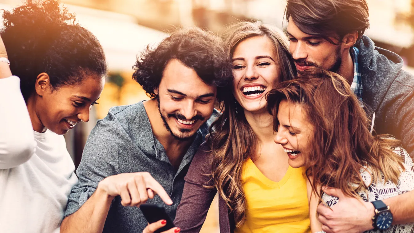 Friends with phone outdoors Smart Phone Five People Social Gathering Text Messaging Leisure Activity Teenage Girls Young Women Women Females Men Group Of People City Life Youth Culture 30-39 Years 20-29 Years Young Adult Teenager Smiling Laughing Fun Cauc
