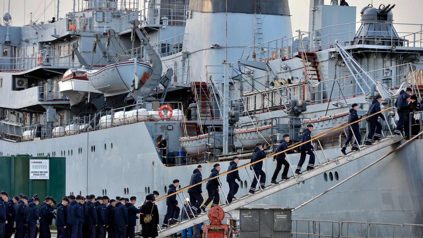 Russian sailors board the training ship Smolny about to leave Saint-Nazaire harbour, on December 18, 2014, where they were training to operate the controversial Mistral-class warship built by France for Russia as Paris agonises over whether to deliver the