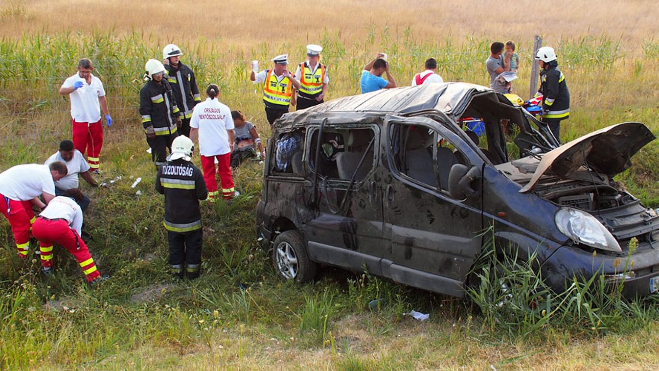Mentősök látják el a sérülteket egy árokba borult, összeroncsolódott mikrobusz mellett az M5-ös autópálya 105-ös és 106-os kilométerszelvénye között, Kunszállás közelében 2013. augusztus 20-án. A kisbuszban ülő tizennégy ember közül kilencen megsérültek