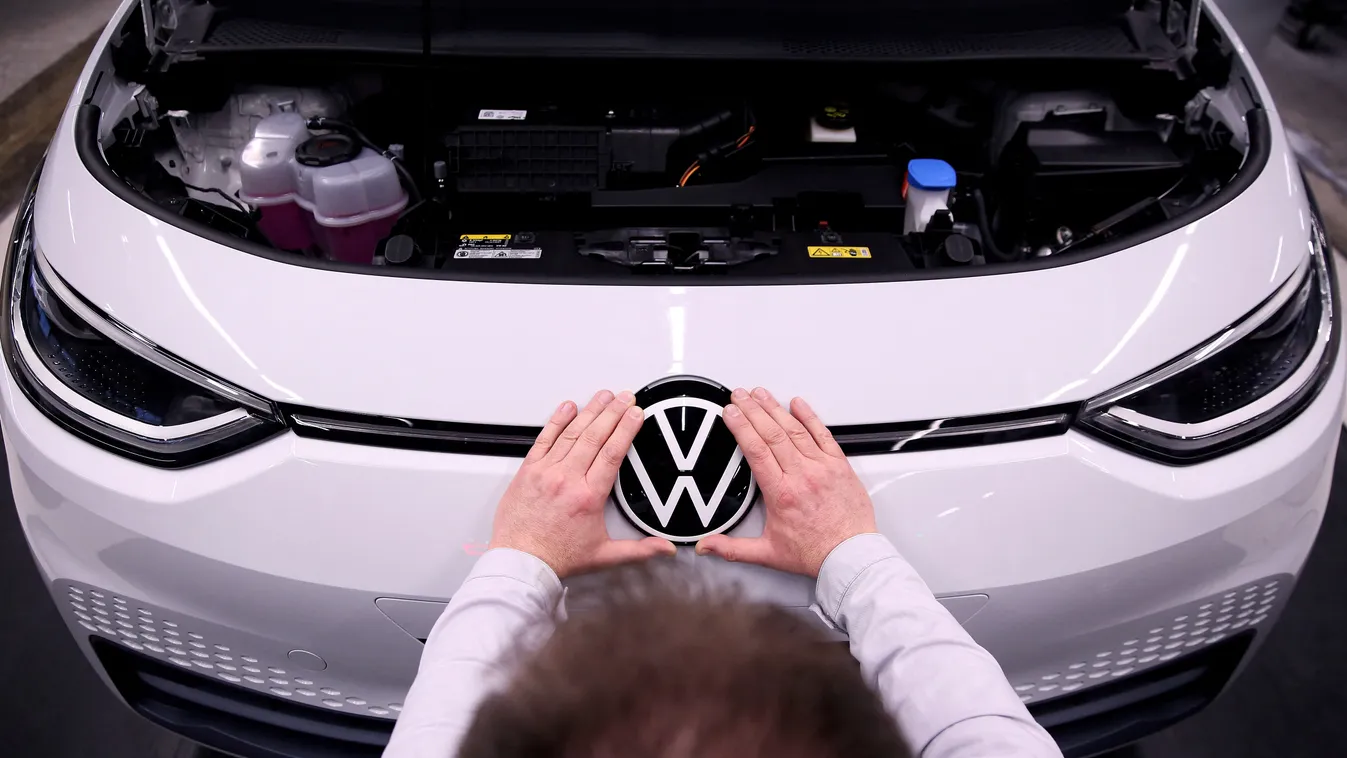 Horizontal AUTO INDUSTRY CAR LOGO ASSEMBLY LINE (FILES) In this file photo taken on February 25, 2020 an employee of German car maker Volkswagen (VW) fixes a VW logo on a Volkswagen ID.3 electric car at an a assembly line of the Volkswagen car factory in 