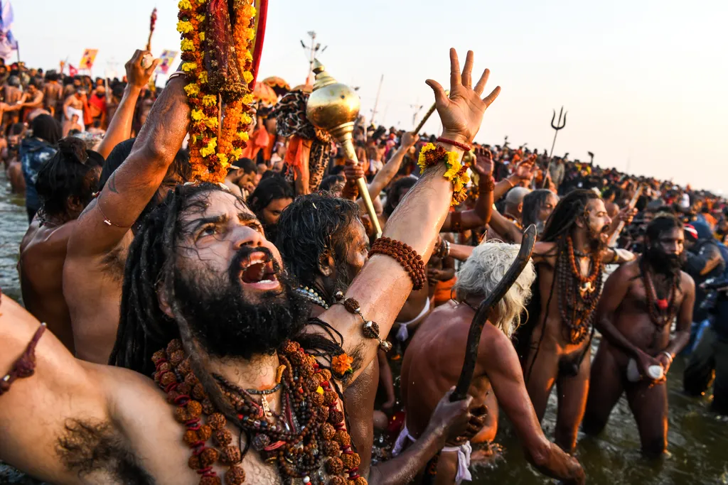 TOPSHOTS Horizontal HINDUISM RELIGIOUS FESTIVAL RIVER RELIGION PILGRIMAGE SADHU RELIGIOUS TRADITION RITUAL CLEANSING SHOUTING RAISED HAND FACE CROWD 