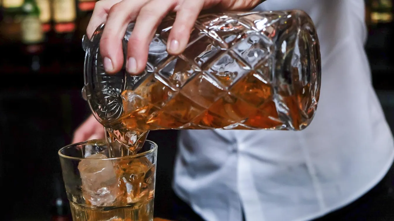 Female bartender pouring scotch Whiskey Pub Crystal Photography Bar Counter After Work Women Females Drinks Utensil Copy Space Cognac - Brandy Collection Gold Colored Whiskey Drinking Glass Ice Cube 20-29 Years Adult Holding Working Pouring Refreshment Ba