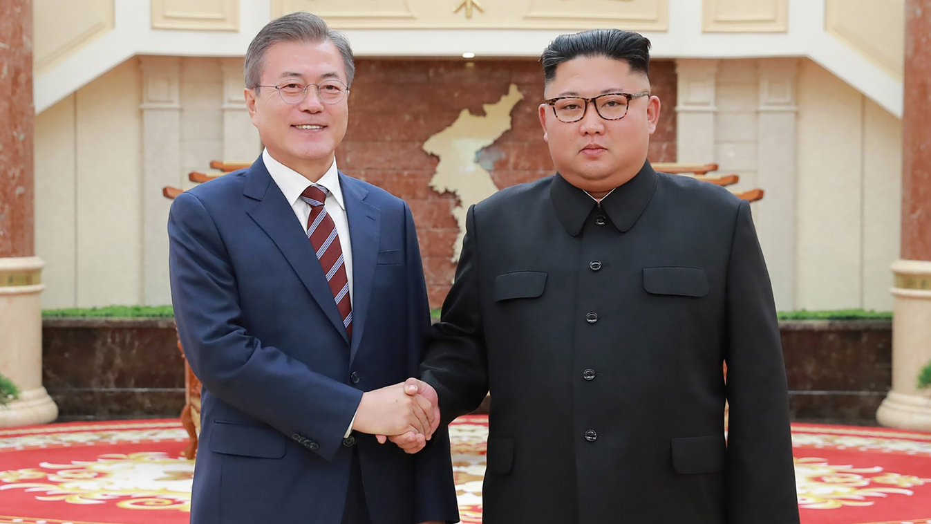 government Horizontal This picture taken on September 18, 2018 and released by Korean Central News Agency (KCNA) via KNS shows North Korean leader Kim Jong Un (R) shaking hands with South Korean President Moon Jae-in (L) before their summit at the Workers