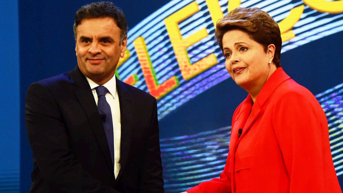 The Presidential candidate for the Brazilian Workers' Party and current President Dilma Rousseff (R) and the presidential candidate for Brazilian Social Democracy Party Aecio Neves shake hands before the start of a television debate in Rio de Janeiro, Bra