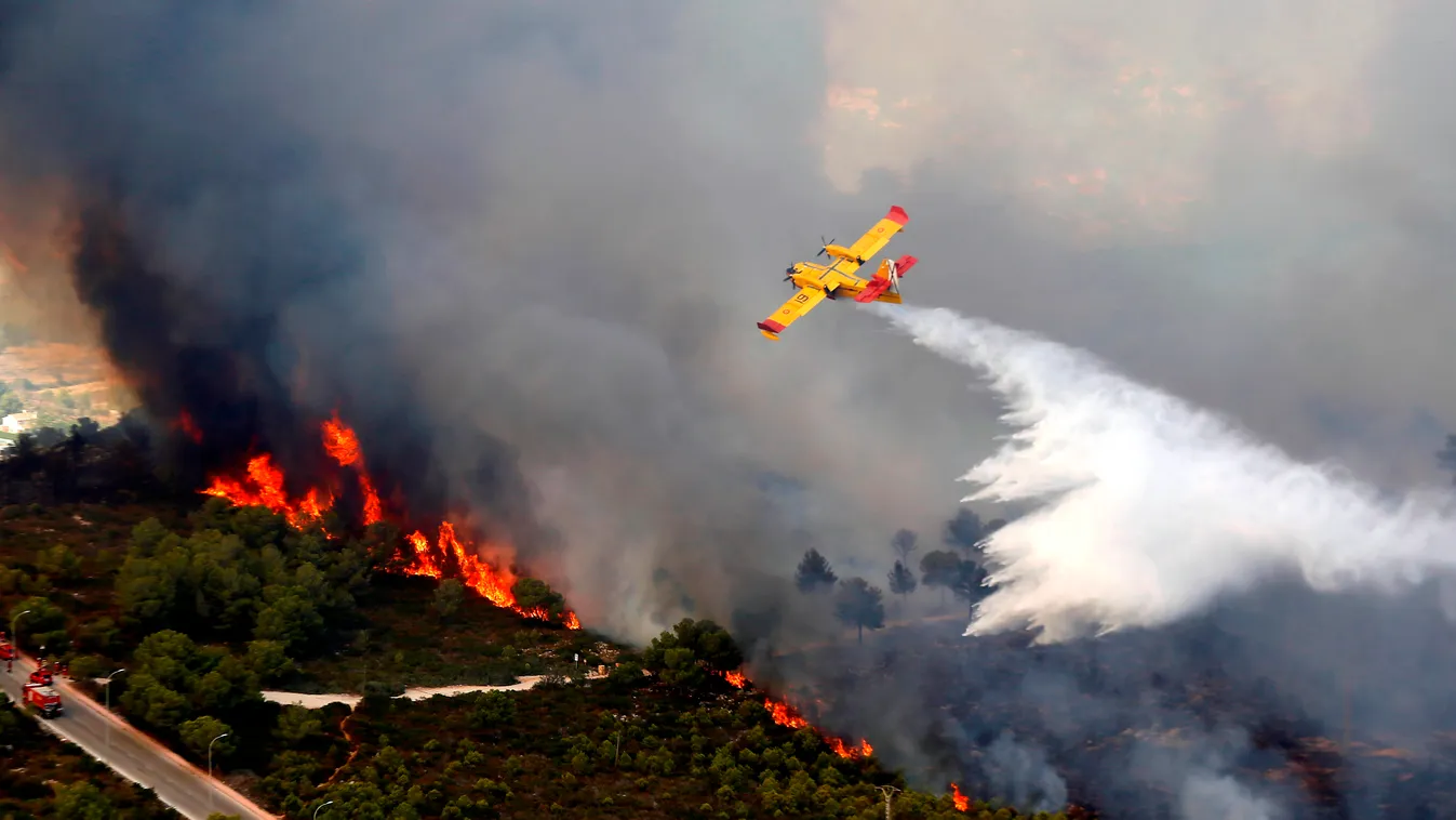 Horizontal (FILES) This file photo taken on September 5, 2016 shows 
a seaplane dropping water over a wildfire next to a residential area along the coastline near the Spanish resort of Javea, Valencia region.
Spain should focus more on preventing forest f