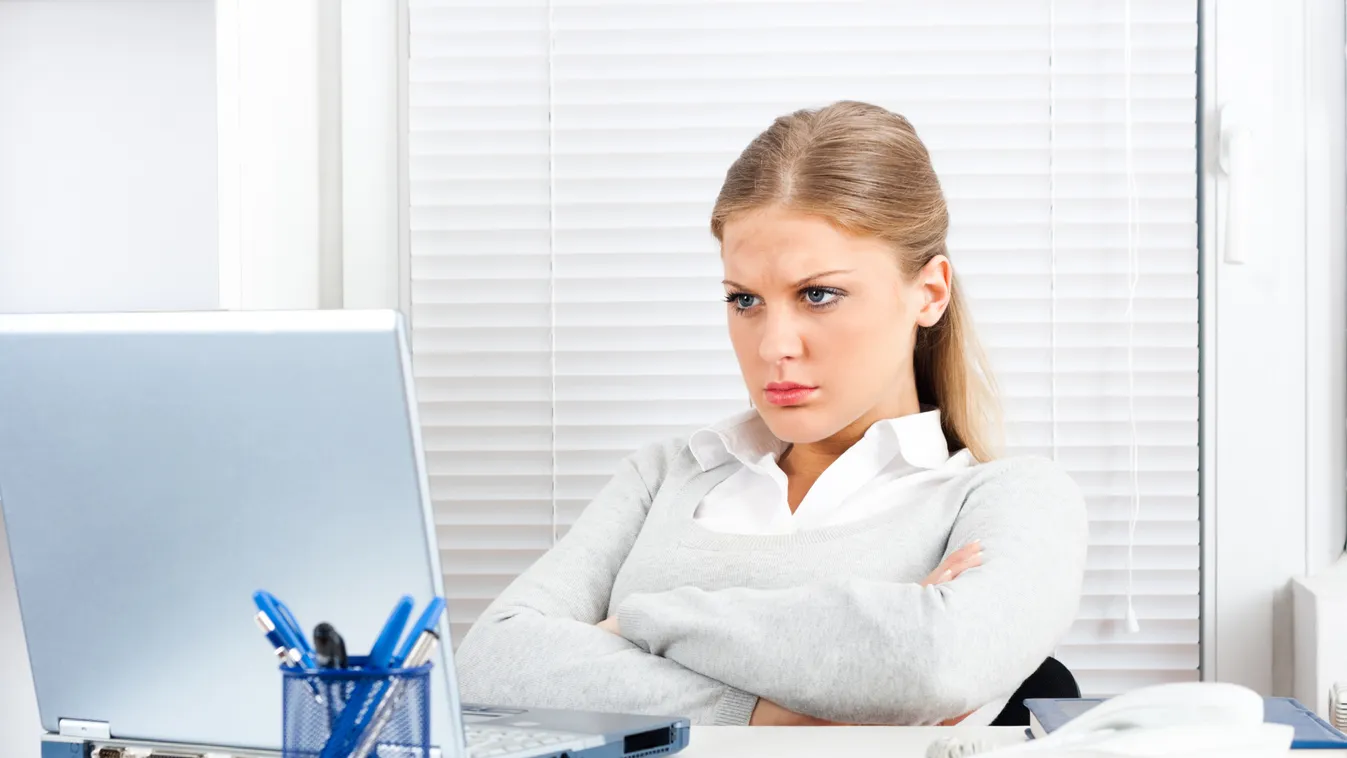 A woman at a desk in front of a laptop with her arms folded Beautiful Using Laptop Computer White Collar Worker Using Computer Businesswoman Portrait One Woman Only Women Facial Expression Global Communications E-Mail Arms Crossed Cute Young Adult Adult F