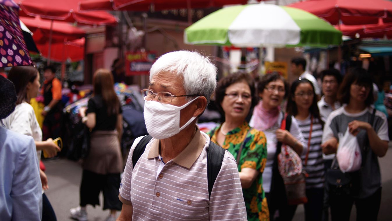A man wearing a face mask walks through a market in Seoul on June 1, 2015. South Korean President Park Geun-Hye scolded health officials over their "insufficient" response to an outbreak of the MERS virus, as the number of infections climbed to 18, with n