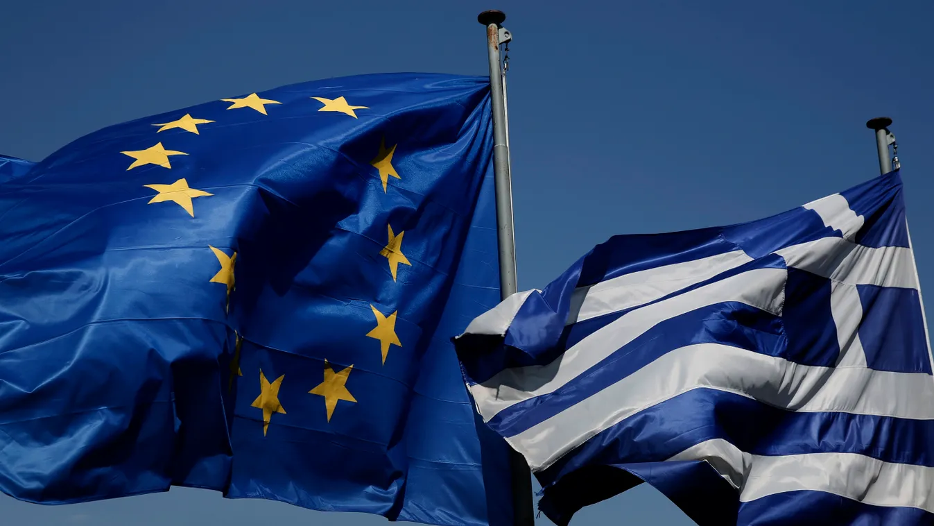 An EU and a Greek flag fly in front of the ancient Parthenon temple, in Athens, Greece görög 