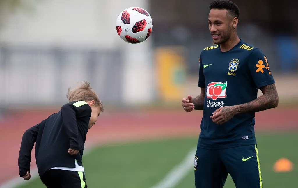 Brazil striker Neymar, during training, plays with his son, David Lucca, at Yug Sport stadium in Sochi, Russia 