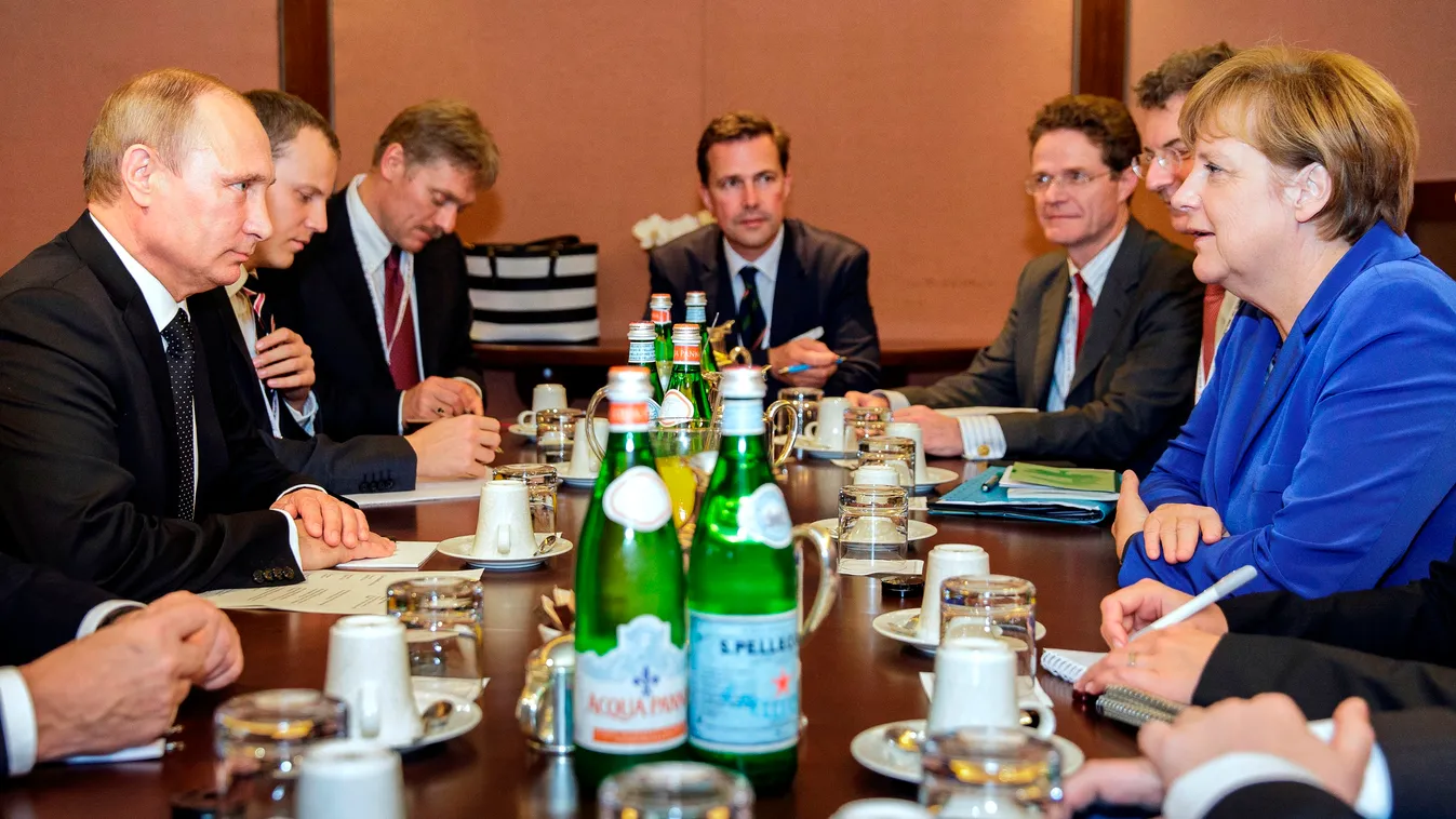 This handout picture taken and released on October 16, 2014 by the German Government shows Russian President Vladimir Putin (L) and German Chancellor Angela Merkel (R) taking part in a bilateral meeting, on the sidelines of the Asia-Europe (ASEM) summit i