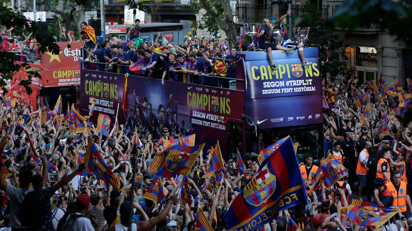 XCHAMPIONSLEAGUEX Fans cheer as FC Barcelona players ride on the team bus during celebrations in Barcelona, Spain Sunday June 7, 2015 after winning the Champions League final soccer match Saturday by beating Juventus Turin 3-1. Barcelona won the triple th