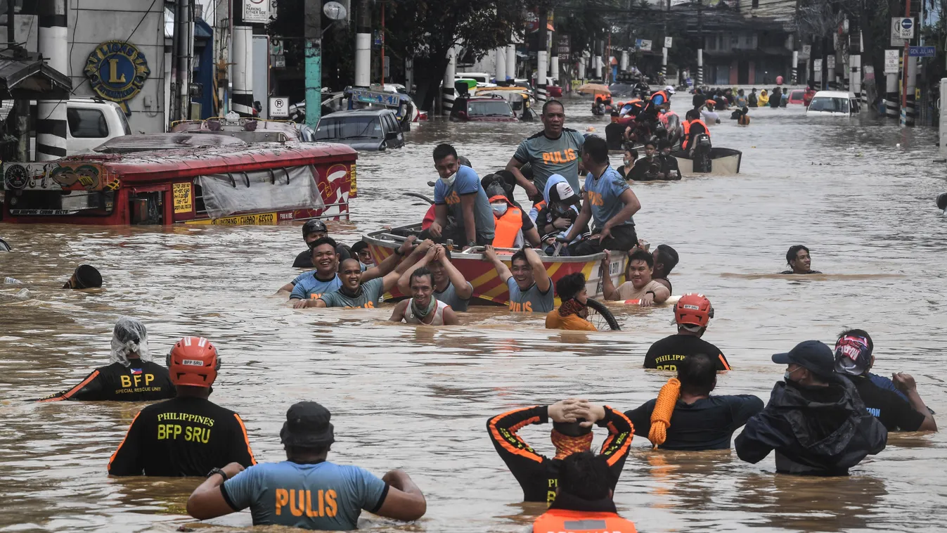 weather Horizontal Rescuers pull a rubber boat carrying residents through a flooded street after Typhoon Vamco hit in Marikina City, suburban Manila on November 12, 2020. (Photo by Ted ALJIBE / AFP) 