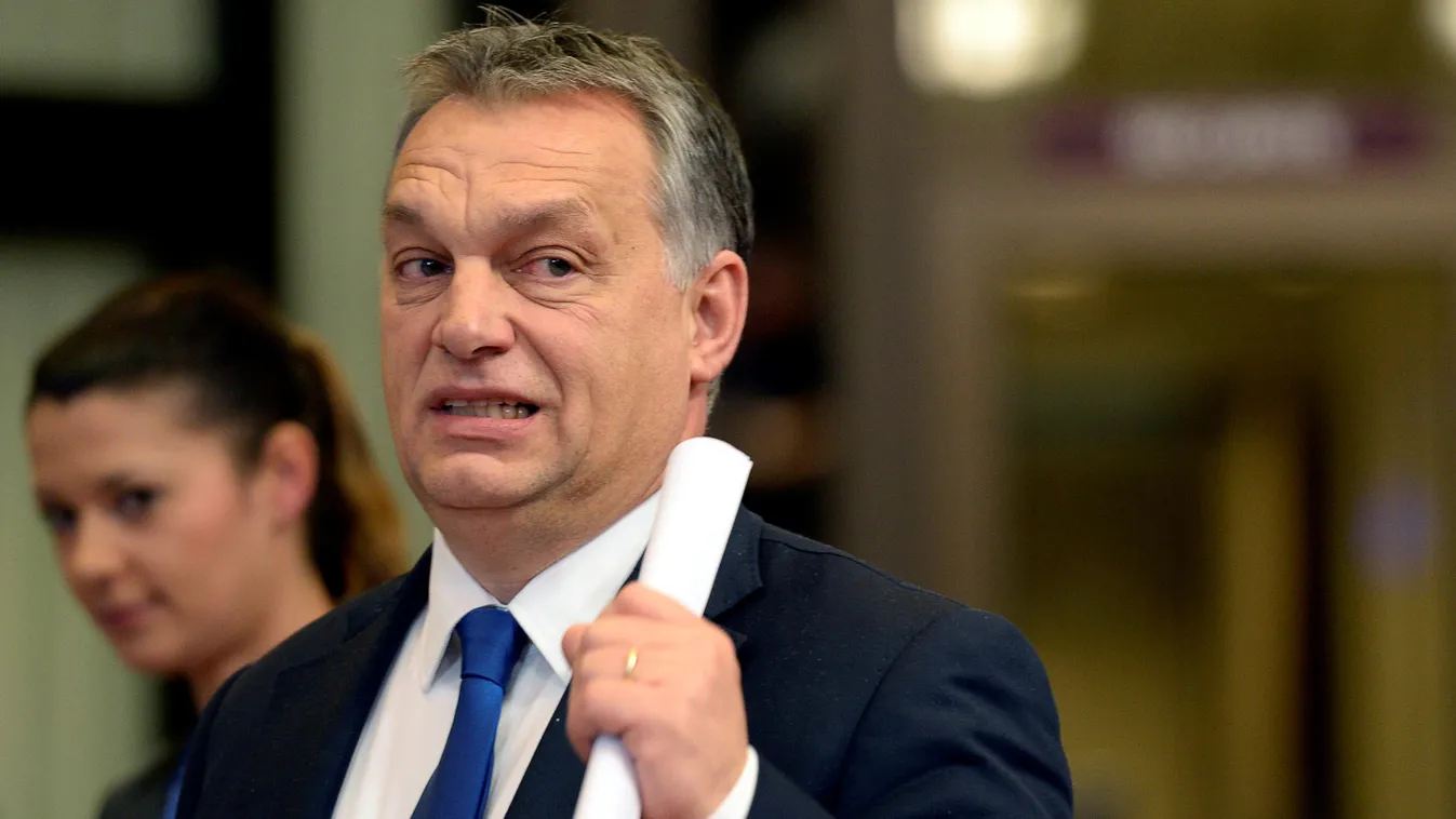 Horizontal Hungarian Prime Minister Viktor Orban reacts as he leaves at the end of a European Union Summit at the EU Council in Brussels on December 18, 2015. / AFP / THIERRY CHARLIER 