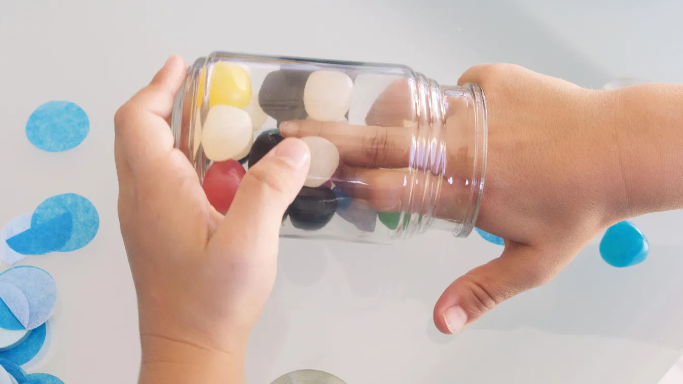 Child reaching into candy jar, cropped CHILD sweet tooth indulgence jar candy sweets HAND only children one person elementary age unhealthy eating temptation FOOD AND DRINK CHILDHOOD enjoyment snack gum drop SUGAR FOOD jelly bean day indoors body part SWE
