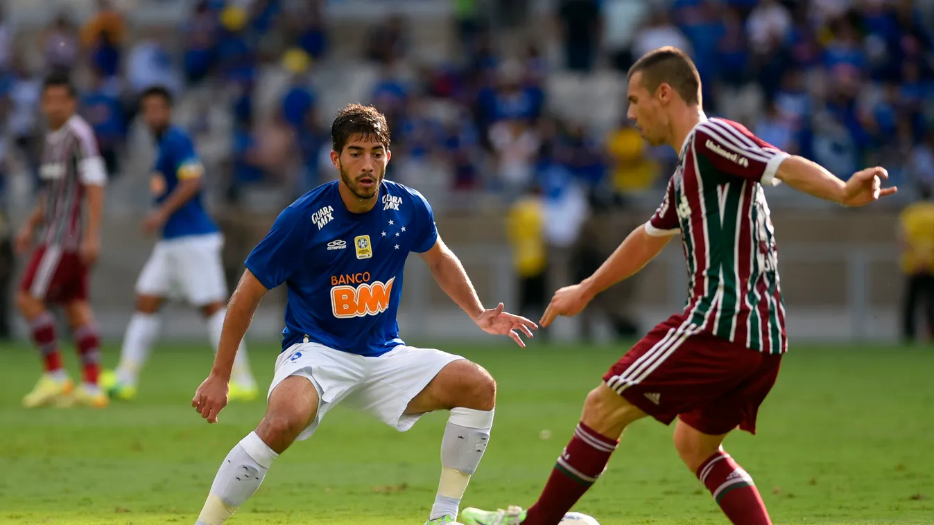 Cruzeiro's player Lucas Silva (L) vies for the ball with Fluminense's player Wagner (R) during their Brazilian Championship football match at Minerao Stadium in Belo Horizonte, Brazil on December 7, 2014. AFP PHOTO / Douglas MAGNO 