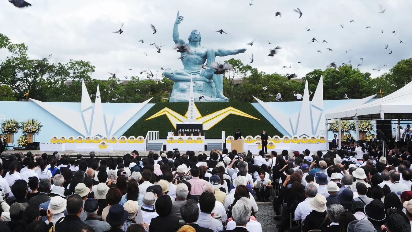 Pigeons fly around the peace statue during a memorial service for victims of the 1945 atomic bombing, at Nagasaki Peace Park on August 9, 2014. Japan marks the 69th anniversary of the US World War II atomic bombing of Nagasaki, as anti-nuclear sentiment r