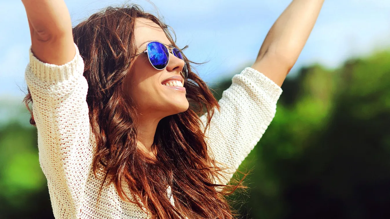 Attractive happy woman in sunglasses enjoying freedom outdoors Adult Beautiful Beauty Brown Hair Caucasian Cheerful Close-up Cute Elegance Facial Expression Fashion Fashion Model Female Glamour Glasses Hand Raised Happiness Healthy Lifestyle Human Hair Hu