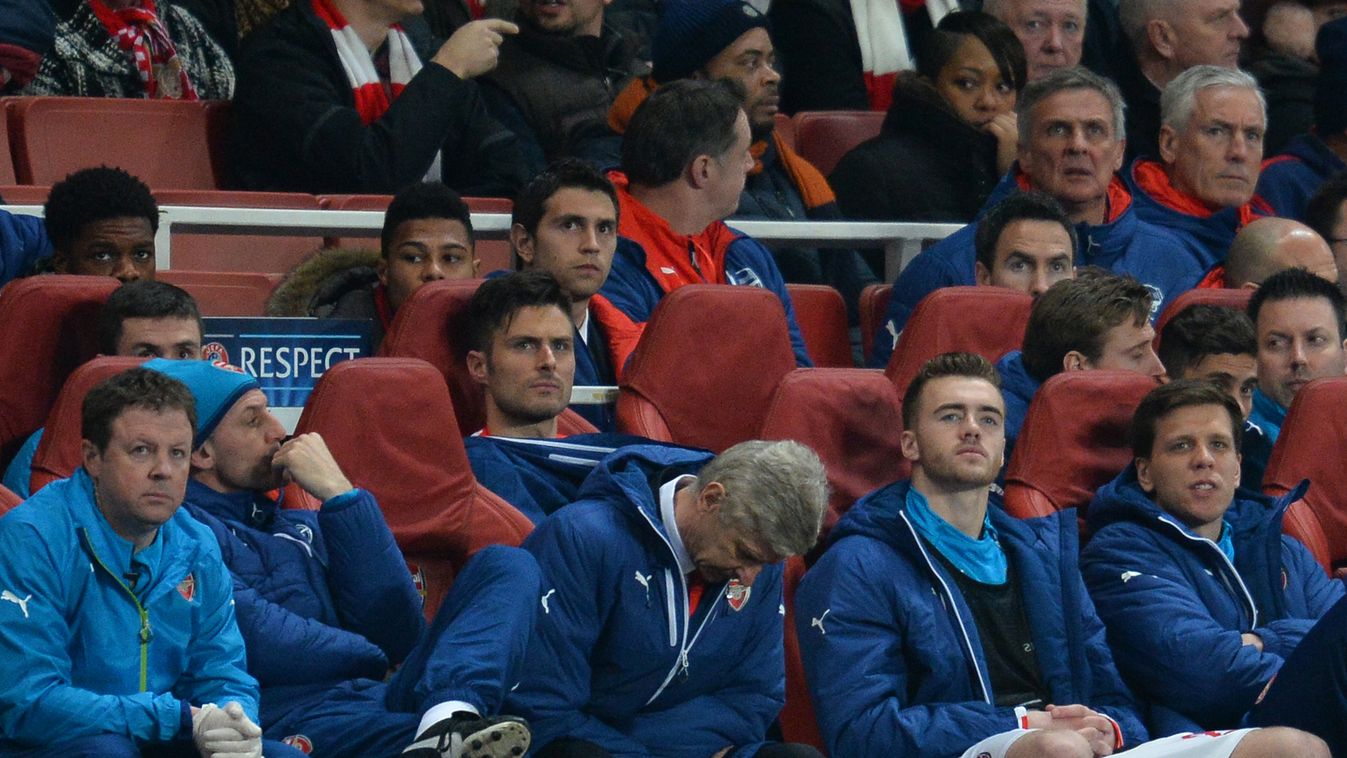 529414865 Arsenal's French manager Arsene Wenger (front row 3L) looks down in his seat in the dug out with unused substitutes Arsenal's English defender Calum Chambers (front row 2R) and Arsenal's Polish goalkeeper Wojciech Szczesny (front row R) and Arse