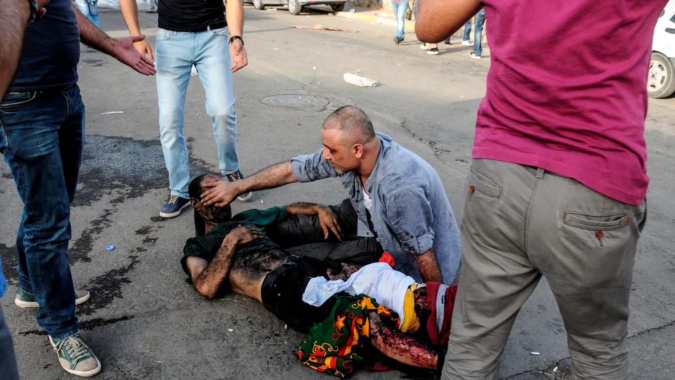 TOPSHOTS
An injured man lies on the ground after two successive blasts which injured dozen of people during a rally by the pro-Kurdish People's Democratic Party (HDP) on June 5, 2015 in the southeastern city of Diyarbakir, two days ahead of legislative po