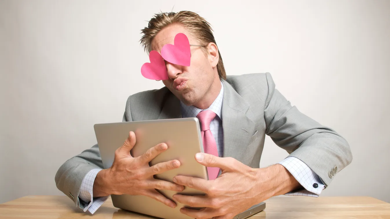 Businessman Office Worker Hugging and Kissing Laptop with Hearts "Using Laptop Computer Internet Dating White Collar Worker Using Computer Businessman Men Male Work Romance Valentine's Day Puckering E-Mail Kissing Embracing Heart Shape Caucasian One Perso
