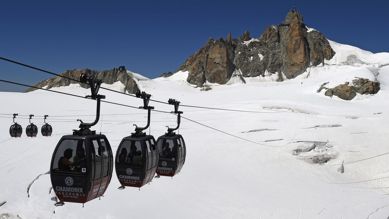 Horizontal (FILES) This file photo taken on August 5, 2015 shows the Panoramic Mont-Blanc cable car linking the Aiguille du Midi peak to the Helbronner peak in Italy, above the seracs and crevasses of the Glacier des Géants (Glacier of the Giants).
About 