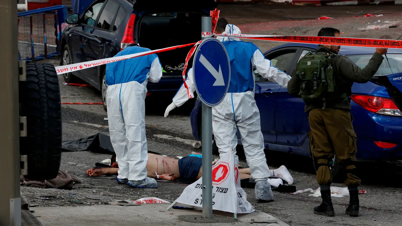 Horizontal Israeli security forces and forensics stand near the body of an alleged Palestinian assailant who was shot following an attack in the West Bank village of Hizma, north of Jerusalem, in which an Israeli soldier was wounded, the army said in a st