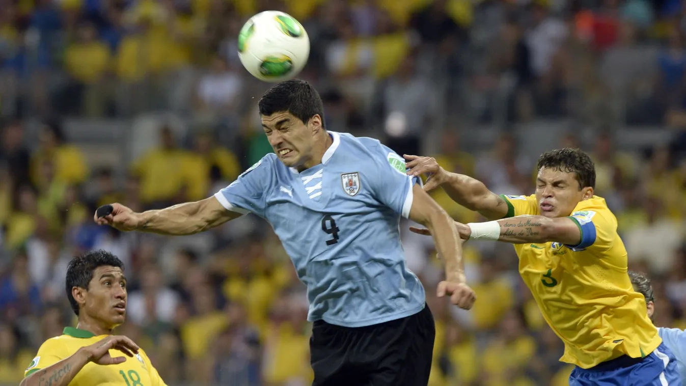Uruguay's forward Luis Suarez (C) heads the ball next to Brazil's midfielder Paulinho (L) and defender Thiago Silva during their FIFA Confederations Cup Brazil 2013 semifinal football match, at the Mineirao Stadium in Belo Horizonte on June 26, 2013.  AFP