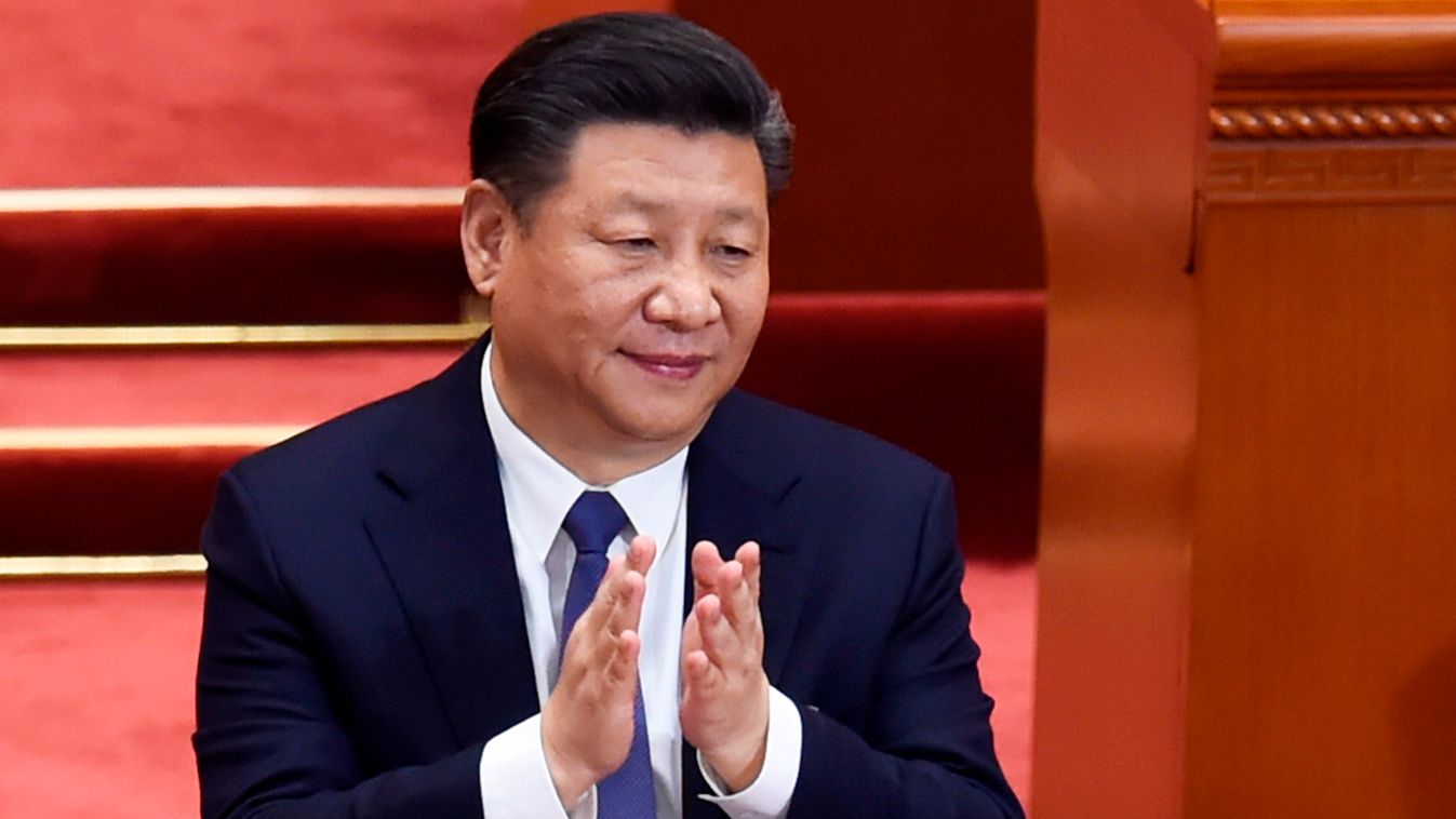Horizontal China's President Xi Jinping applauds after the voting result are announced during the third plenary session of the first session of the 13th National People's Congress (NPC) at the Great Hall of the People in Beijing on March 11, 2018.
China's