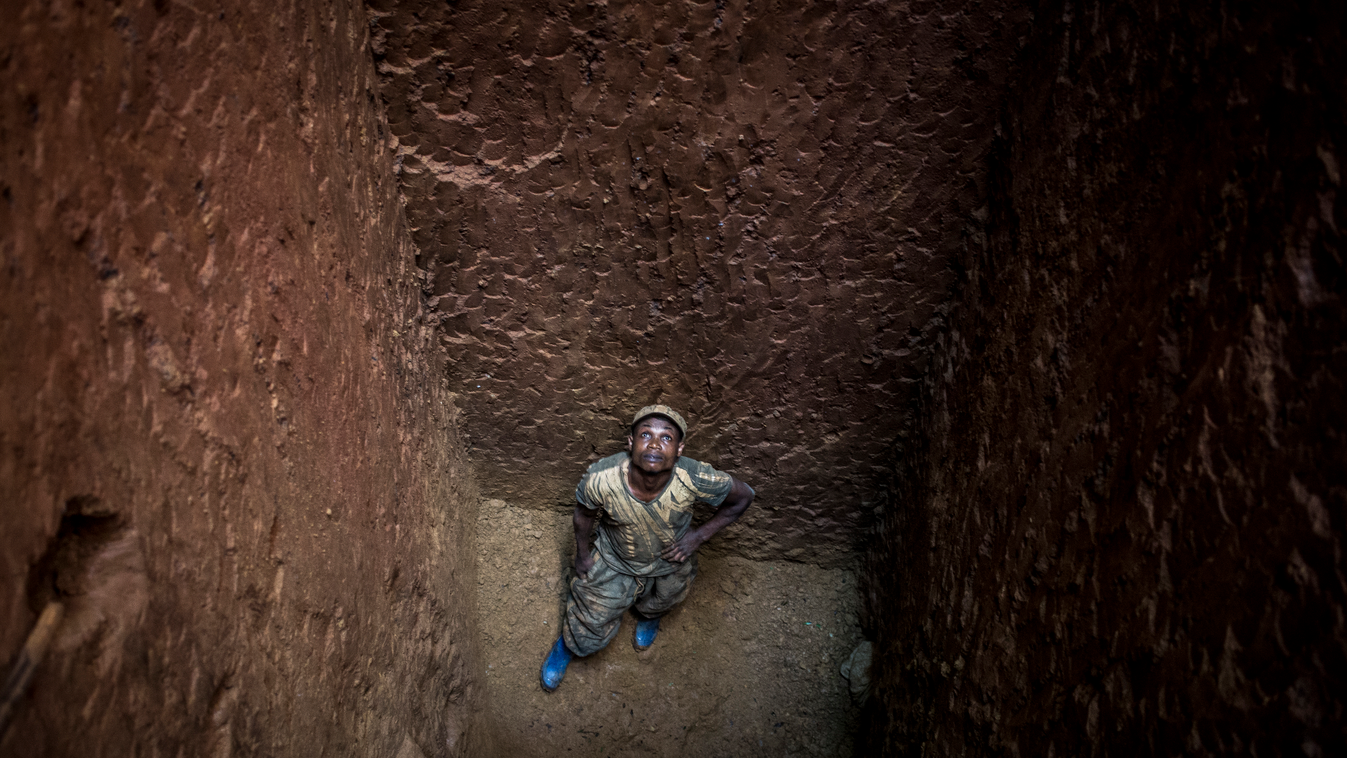 A Congolese artisanal miner is seen at the bottom of a deep gold mine in the Mabakulu site on July 11, 2018 in Ituri Province. The Mabakulu Gold Mining site lies deep within the Ituri Forest. Miners will stay out in the forest for up to a week, by the end