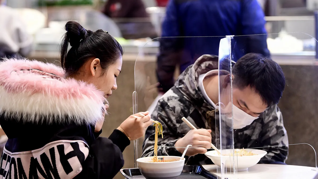 virus Horizontal People eat at a restaurant using transparent boards to separate people, amid concerns about the spread of the COVID-19 coronavirus, in Shenyang in China's northeastern Liaoning province on March 2, 2020. - The global death toll from the C