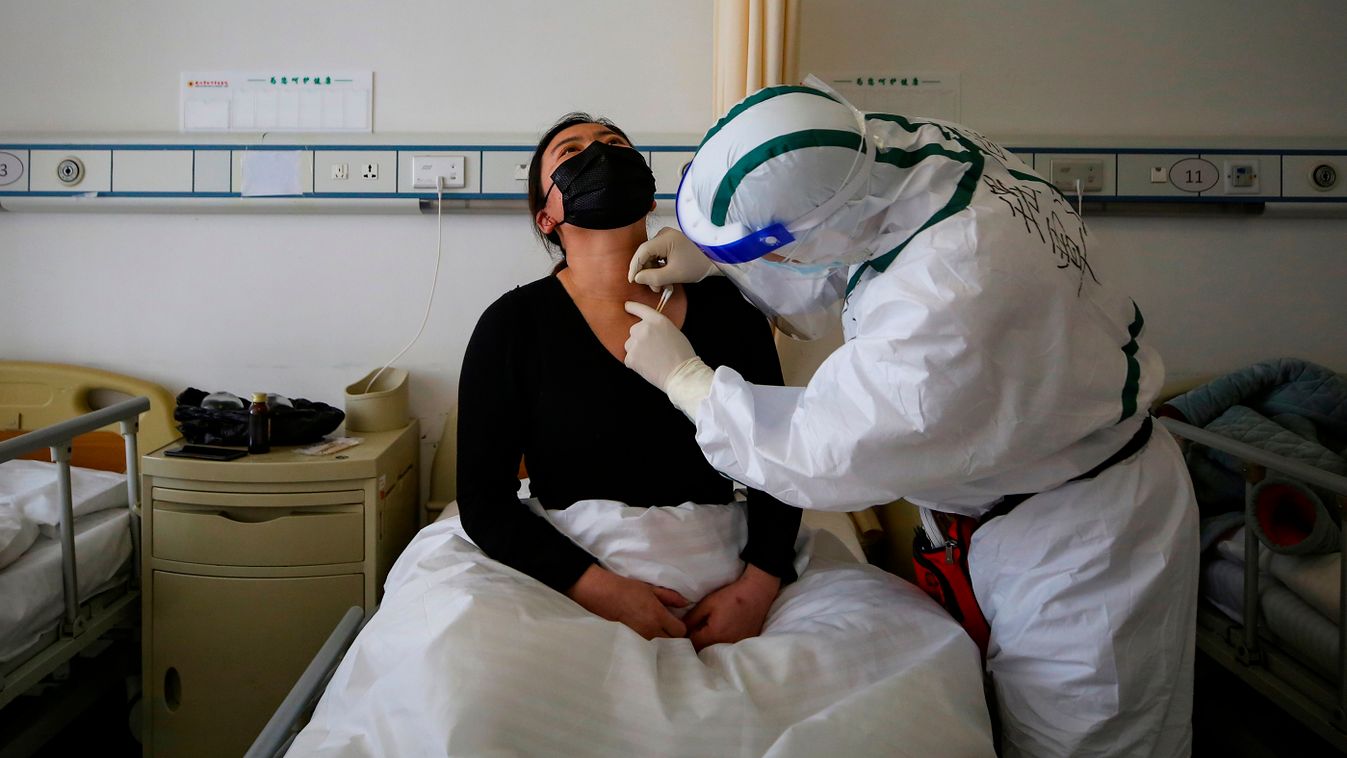 TOPSHOTS Horizontal HEALTH EPIDEMIC CORONAVIRUS MEDICAL STAFF ACUPUNCTURE HAZMAT SUIT HOSPITAL ROOM A patient (L) infected by the COVID-19 coronavirus receives acupuncture treatment at Red Cross Hospital in Wuhan in China's central Hubei province on March