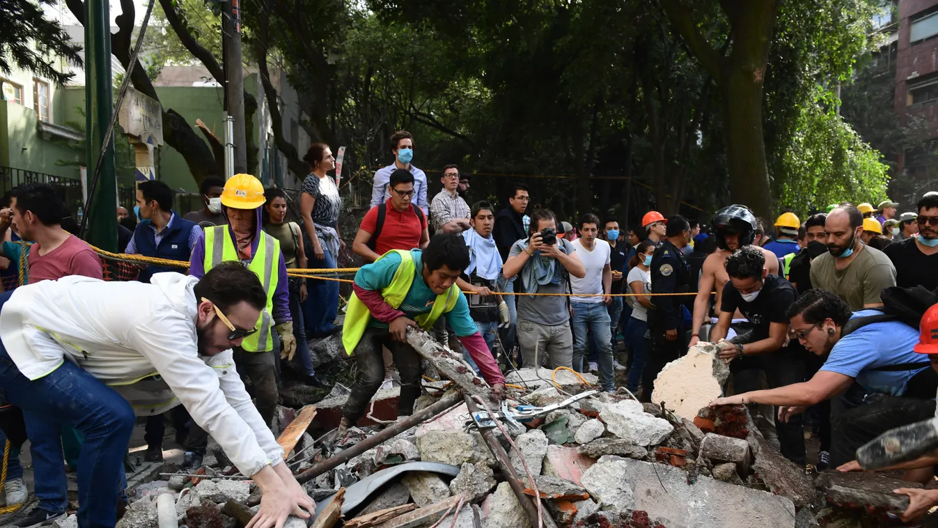 Horizontal Rescuers look for survivors in a multistory building flattened by a powerful quake in Mexico City on September 19, 2017.
A devastating quake in Mexico on Tuesday killed more than 100 people, according to official tallies, with a preliminary 30 