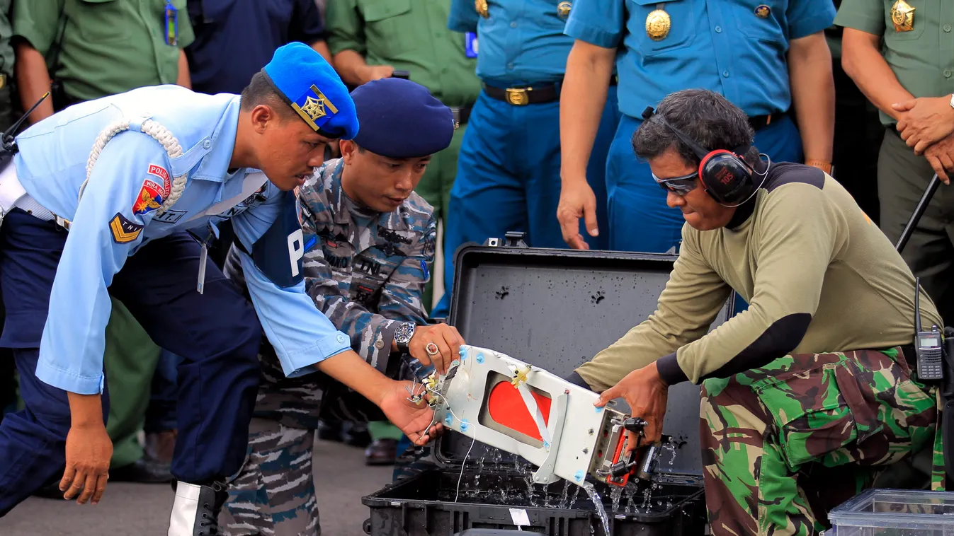 Pangkalan Bun, 2015. január 12. 
Az AirAsia malajziai légitársaság lezuhant gépe egyik megtalált adatrögzítő fekete dobozát nézik a mentőalakulatok tagjai az indonéziai Pangkalan Bun katonai repülőterén 2015. január 12-én. (MTI/EPA/Bagus Indahono) 