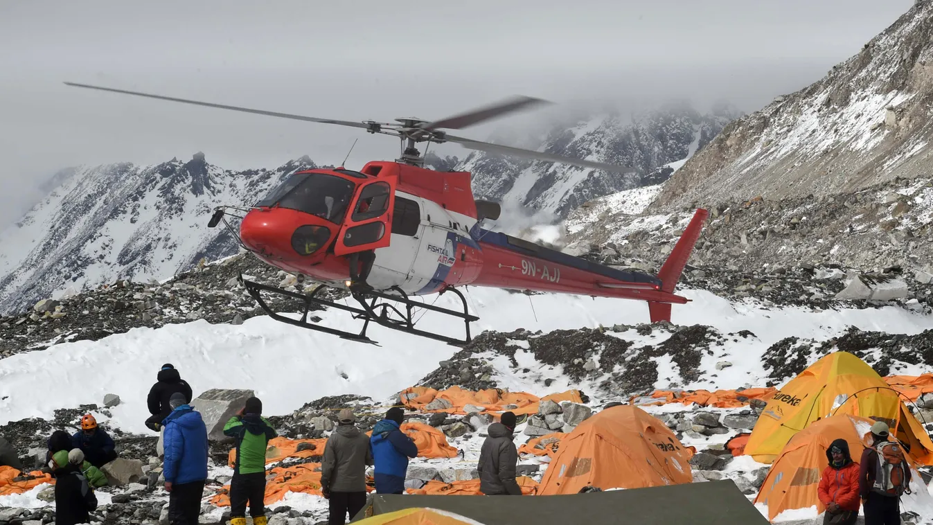 A rescue helicopter prepares to land and airlift the injured from Everest Base Camp on April 26, 2015, a day after an avalanche triggered by an earthquake devastated the camp.  Rescuers in Nepal are searching frantically for survivors of a huge quake on A