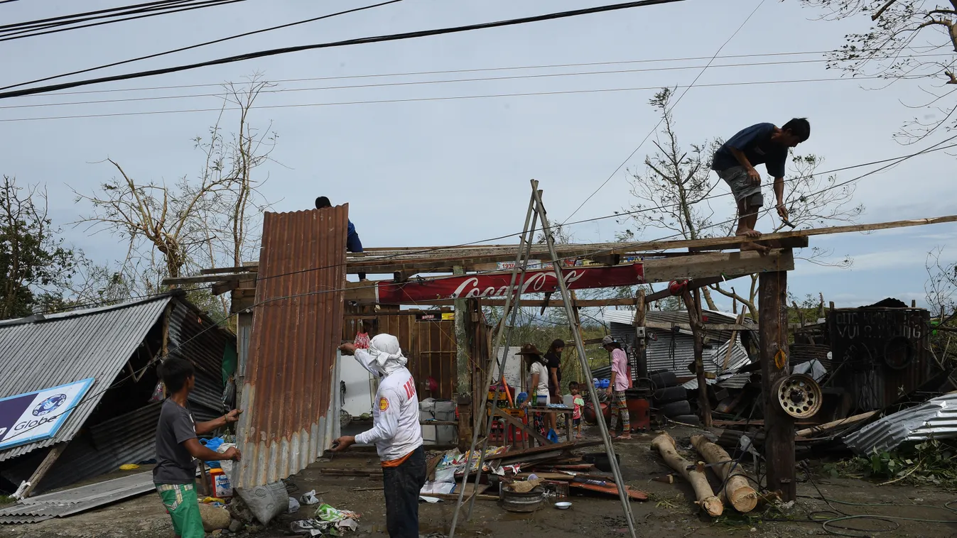 Horizontal A family fix the roof of their damaged house at the height of typhoon Haima in Ilagan town, Isabela province, north of Manila on October 20, 2016.
One of the most powerful typhoons to ever hit the Philippines destroyed houses, tore roofs off sc