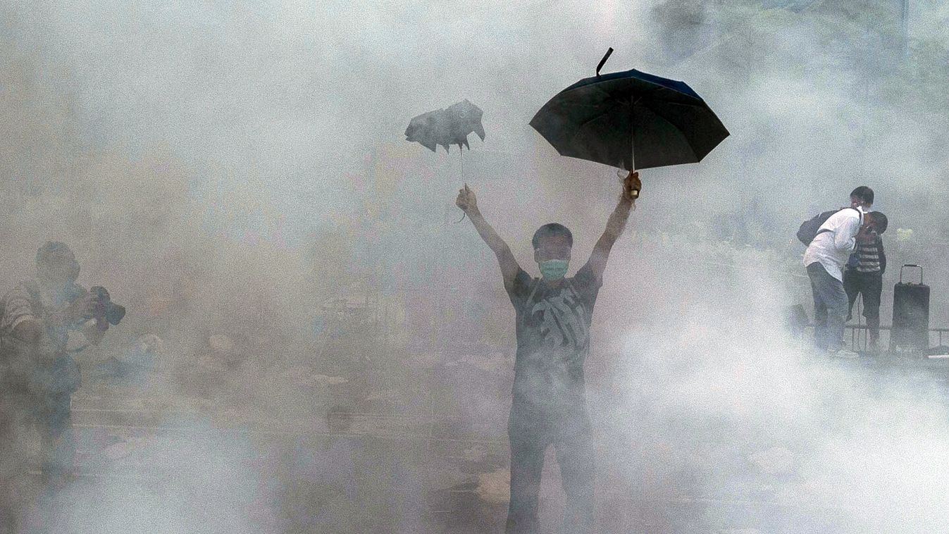 GettyImageRank3 TOPSHOTS
A pro-democracy demonstrator gestures after police fired tear gas towards protesters near the Hong Kong government headquarters on September 28, 2014. Police fired tear gas as tens of thousands of pro-democracy demonstrators broug