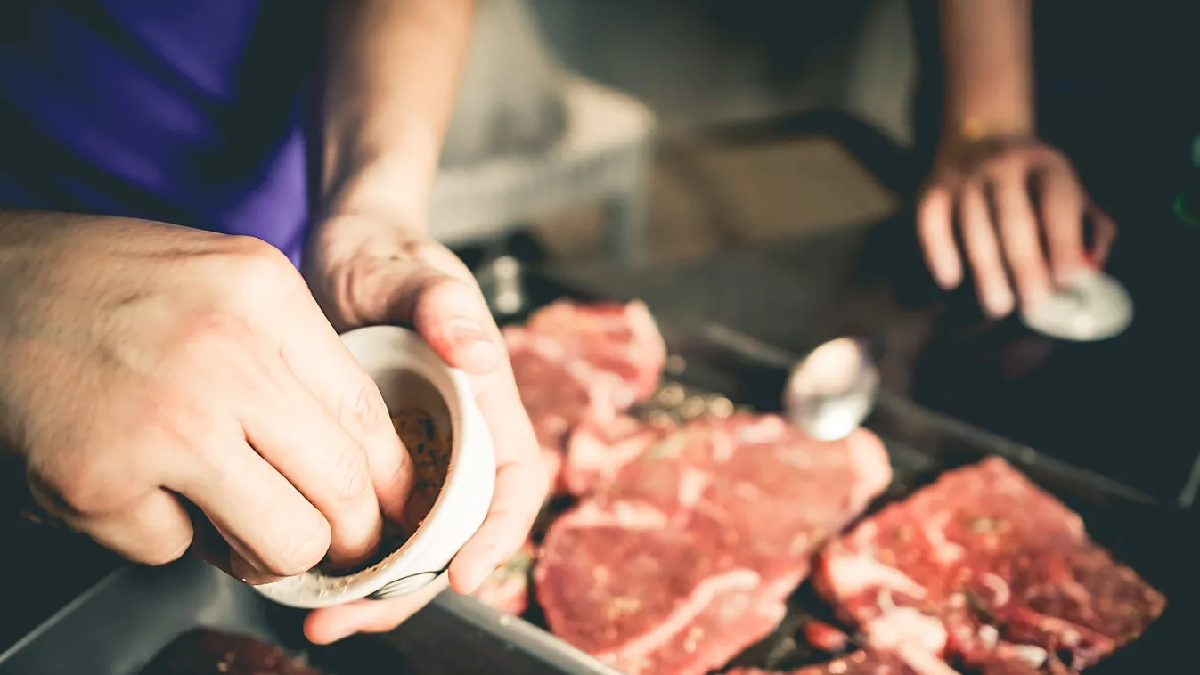 Human hand is preparing BBQ steak for party. Dining Barbecue Grill Seasoning Men Males Raw Food Steak Beef Barbecue Adult Holding Cooking One Person Preparation Human Hand Chef Professional Occupation Occupation Decoration Restaurant Party - Social Event 