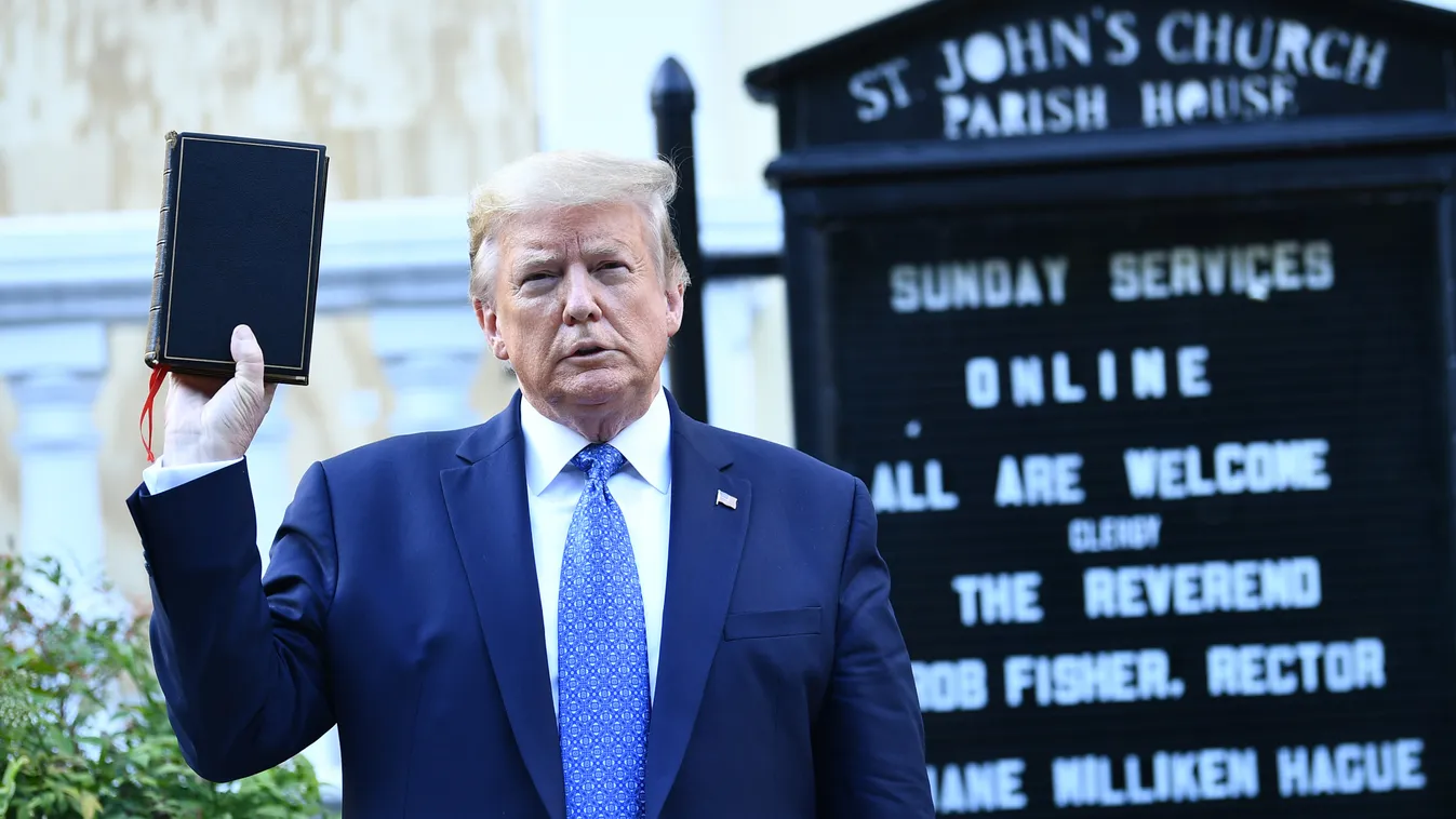 Horizontal US President Donald Trump holds up a bible in front of St John's Episcopal church after walking across Lafayette Park from the White House in Washington, DC on June 1, 2020. - US President Donald Trump was due to make a televised address to the