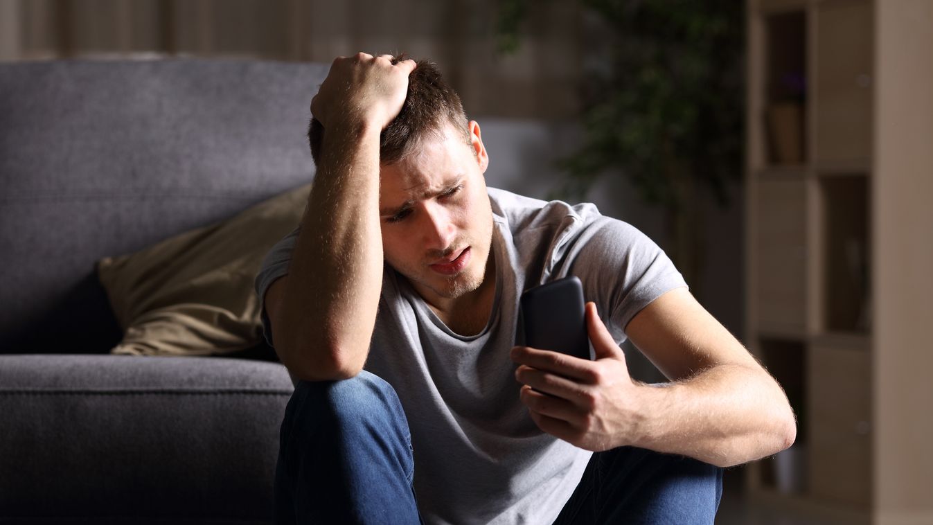 Sad man checking mobile phone sad phone alone depressed man teen mobile media social guy breakup angry crying cellphone desperate rejected young anxious text stressed news unhappy bad break up divorce smart internet cyber bullying smartphone worried death