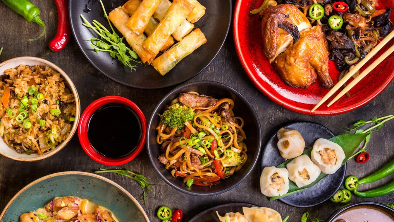 Assorted Chinese food set. Chinese noodles, fried rice, dumplings, peking duck, dim sum, spring rolls. Famous Chinese cuisine dishes on table. Top view. Chinese restaurant concept. Asian style banquet 