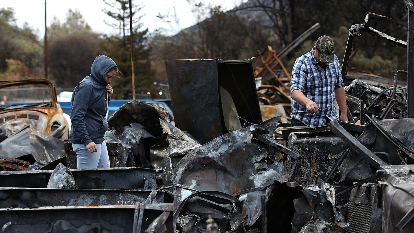 Horizontal FIRE (FILES) In this file photo taken on November 22, 2018 Noah Fisher (R) and Dusty Cope (L)  look through the remains of their home that was destroyed by the Camp Fire  in Paradise, California. - The deadliest and most destructive fire in Cal