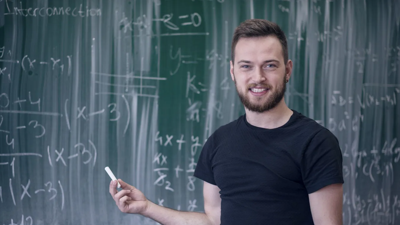 Handsome Young Student Showing on School Blackboard Male Beauty Student Portrait Men Males Copy Space Mathematics Presentation Inspiration Facial Expression Training Class Young Adult Writing Smiling Explaining Standing Looking Thinking Holding Showing In