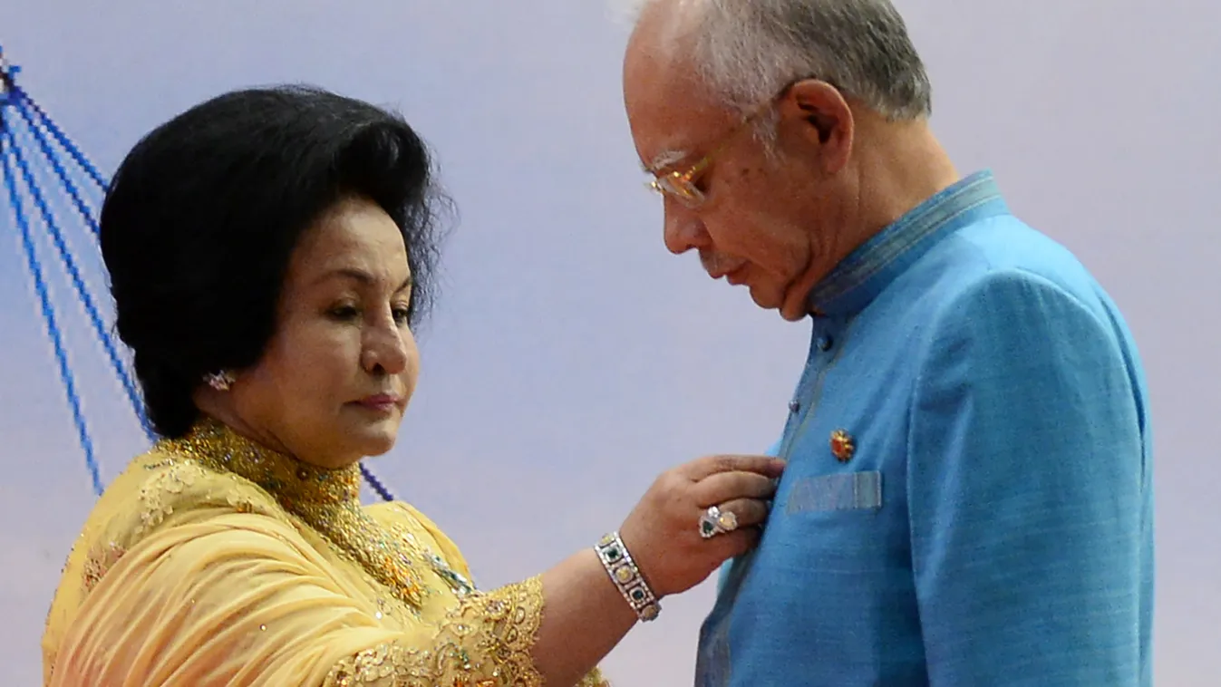 crime politics Vertical (FILES) This file photo taken on April 26, 2015 shows Rosmah Mansor (L), wife of Malaysian Prime Minister Najib Razak (R), adjusting her husband's shirt as they wait for a group photo before a gala dinner in honour of ASEAN heads o