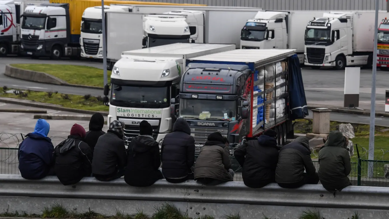 Horizontal MIGRATION AND IMMIGRATION MIGRANT SEATED BACK VIEW PARKING SPACE LORRY CRASH BARRIER 