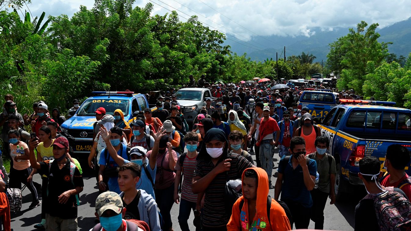 migration Horizontal Honduran migrants, part of a caravan heading to the US, walk in Entre Rios, Guatemala, after crossing the border from Honduras, on October 1, 2020. - A new caravan, of at least 5,000 people, left San Pedro Sula on Wednesday midnight i