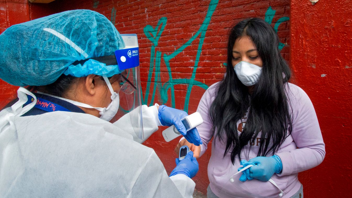 health virus pandemic vaccines Horizontal A health worker measures blood oxygenation to a woman before administering a flu vaccine in Mexico City, on October 3, 2020. - A national free flu vaccination campaign started in Mexico amid the COVID- 19 coronavi