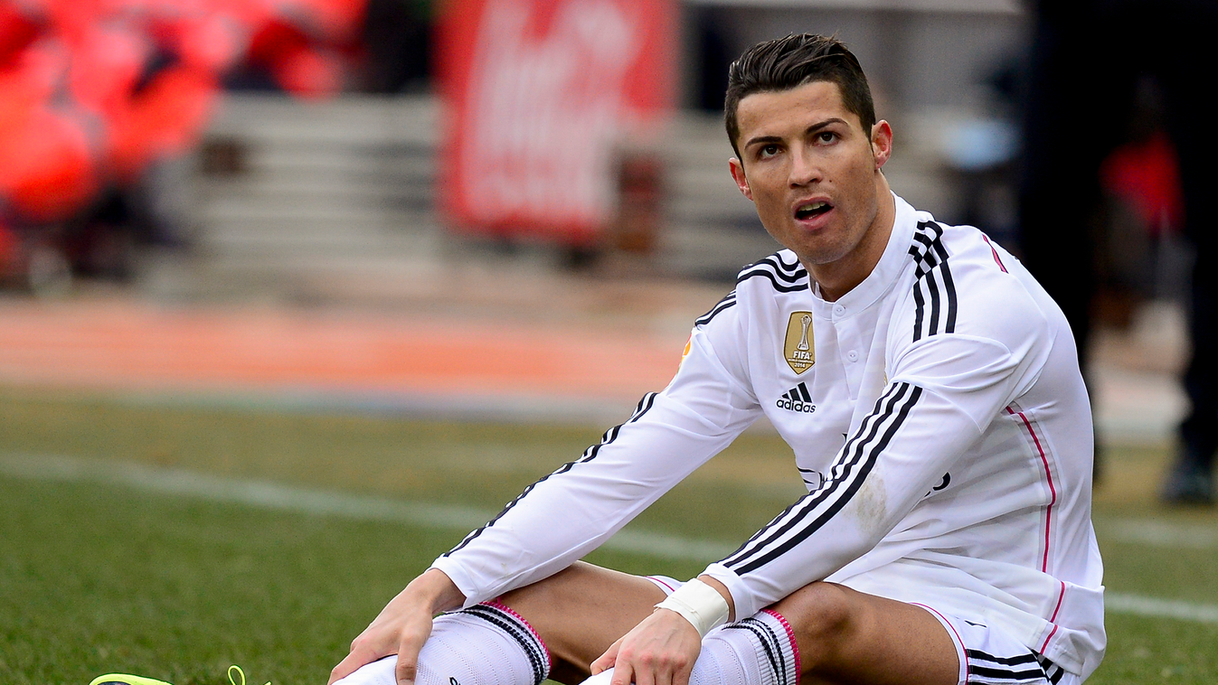 504075427 Real Madrid's Portuguese forward Cristiano Ronaldo reacts as he sits on the pitch during the Spanish league football match Club Atletico de Madrid vs Real Madrid CF at the Vicente Calderon stadium in Madrid on February 7, 2015. AFP PHOTO/ DANI P