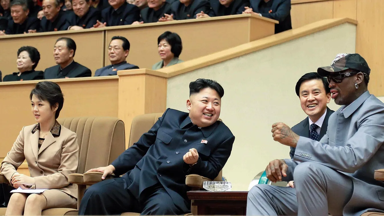 This photo taken on January 08, 2014 and released by North Korea's official Korean Central News Agency (KCNA) on January 9, 2014 shows North Korean leader Kim Jong-Un (C), his wife Ri Sol-Ju (L) and former US basketball star Dennis Rodman (R) watching a b