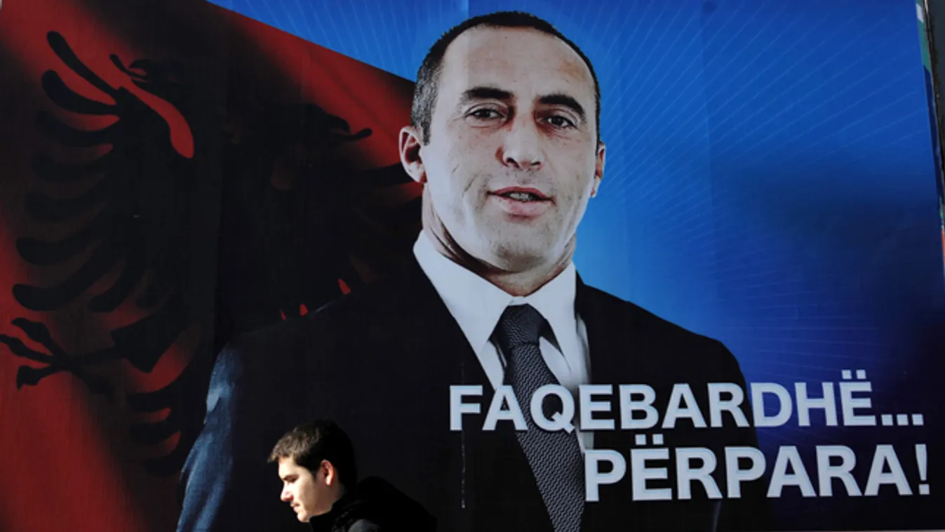 Ramush Haradinaj, korábbi koszovói miniszterelnök plakátja előtt sétál el egy koszovói albán férfi