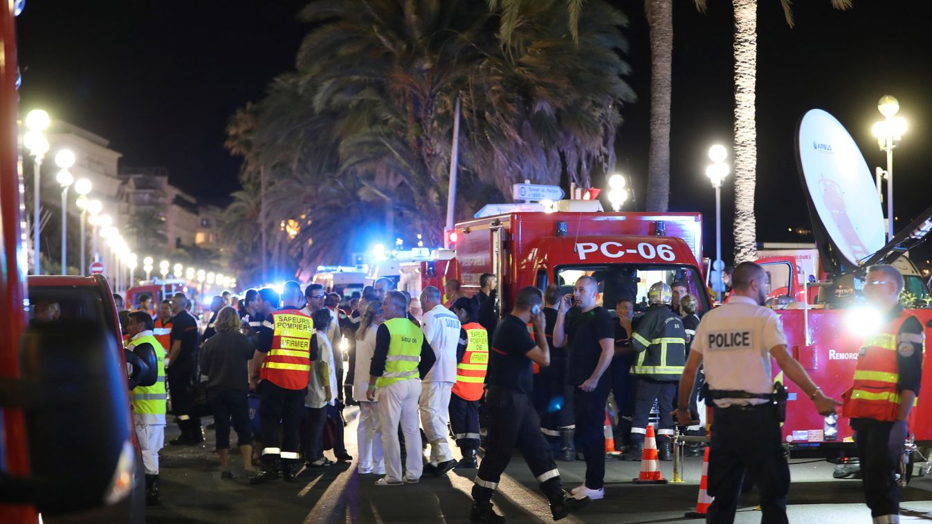 crime Horizontal Police officers, firefighters and rescue workers are seen at the site of an attack on July 15, 2016, after a truck drove into a crowd watching a fireworks display in the French Riviera town of Nice.
A truck ploughed into a crowd in the Fr